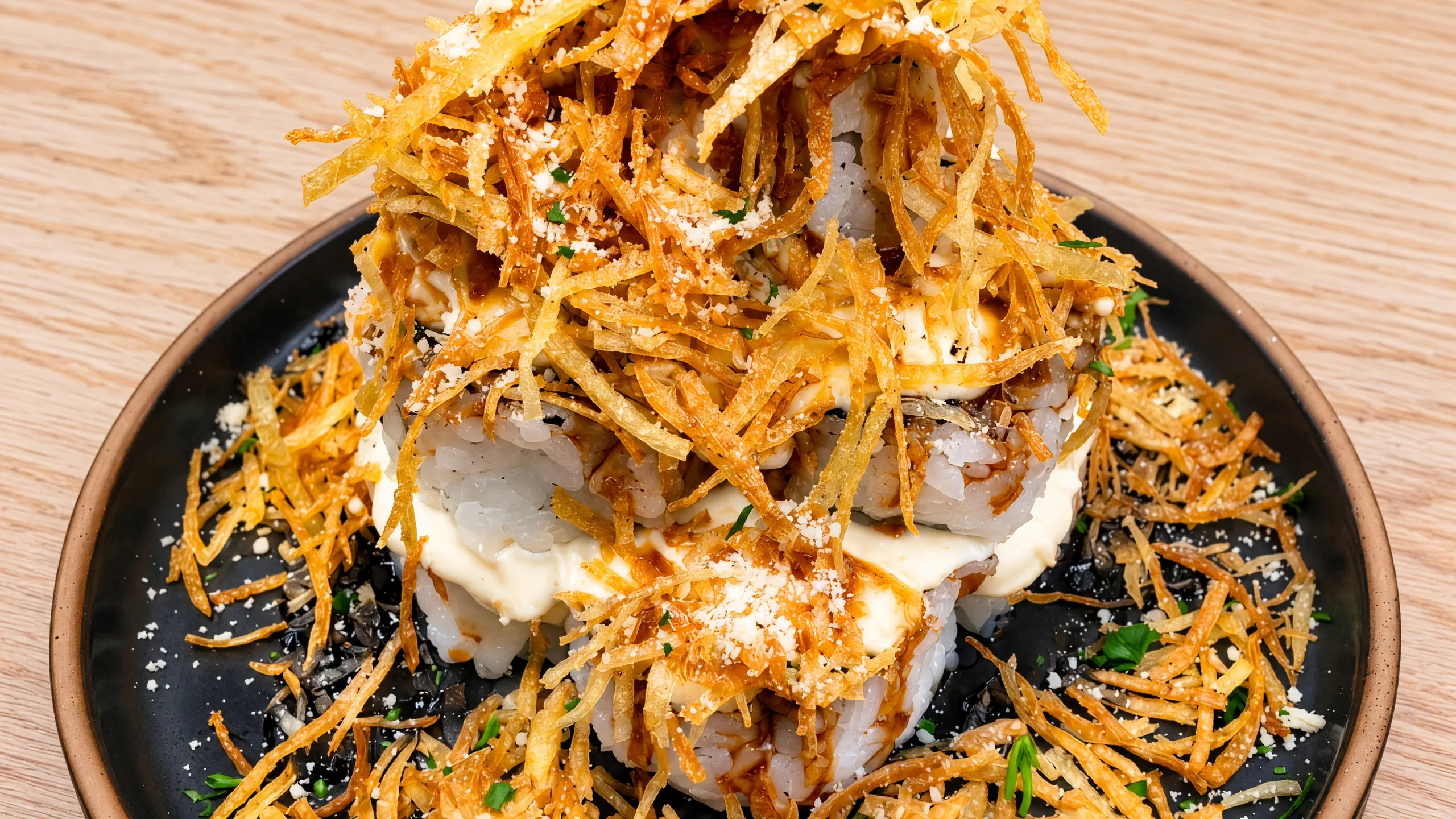 Rocky Mountain Roll piled high with crispy shredded potato and cream cheese sauce