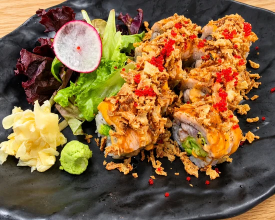 Double Salmon Roll with torched salmon, crispy onion and red tobiko, beside ginger, wasabi and salad